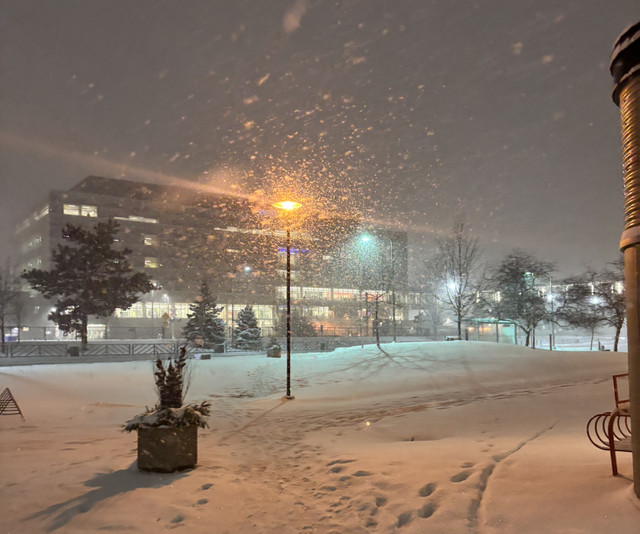 A snowy night outside a building